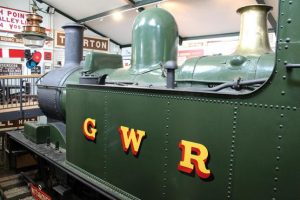 A green steam engine with GWR painted on its side