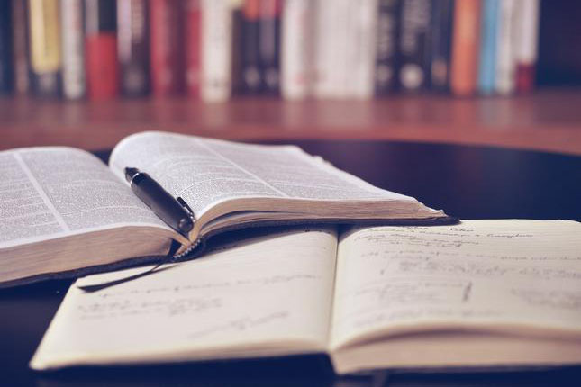 Some open books on a table in a library