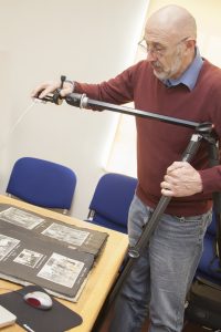 A man photographing archives with a camera in a stand