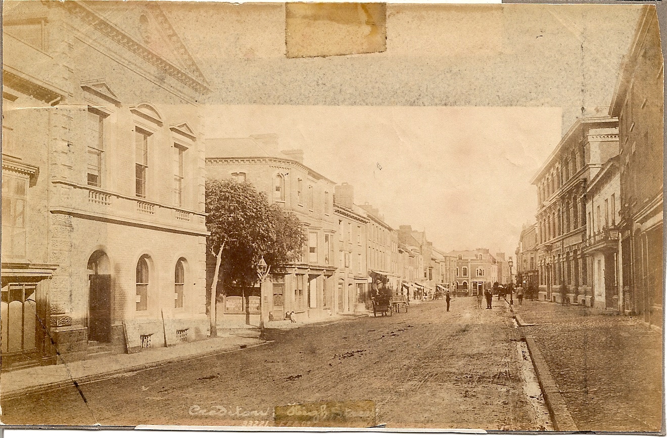 An old sepia photograph showing Crediton High Street