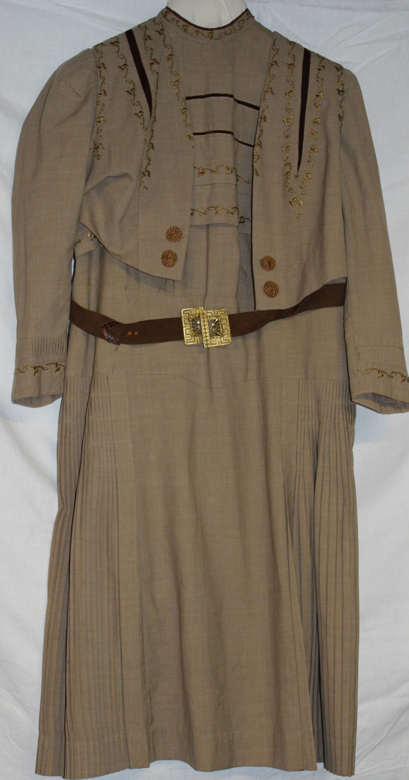 Brown long sleeved dress with embroidery across bodice