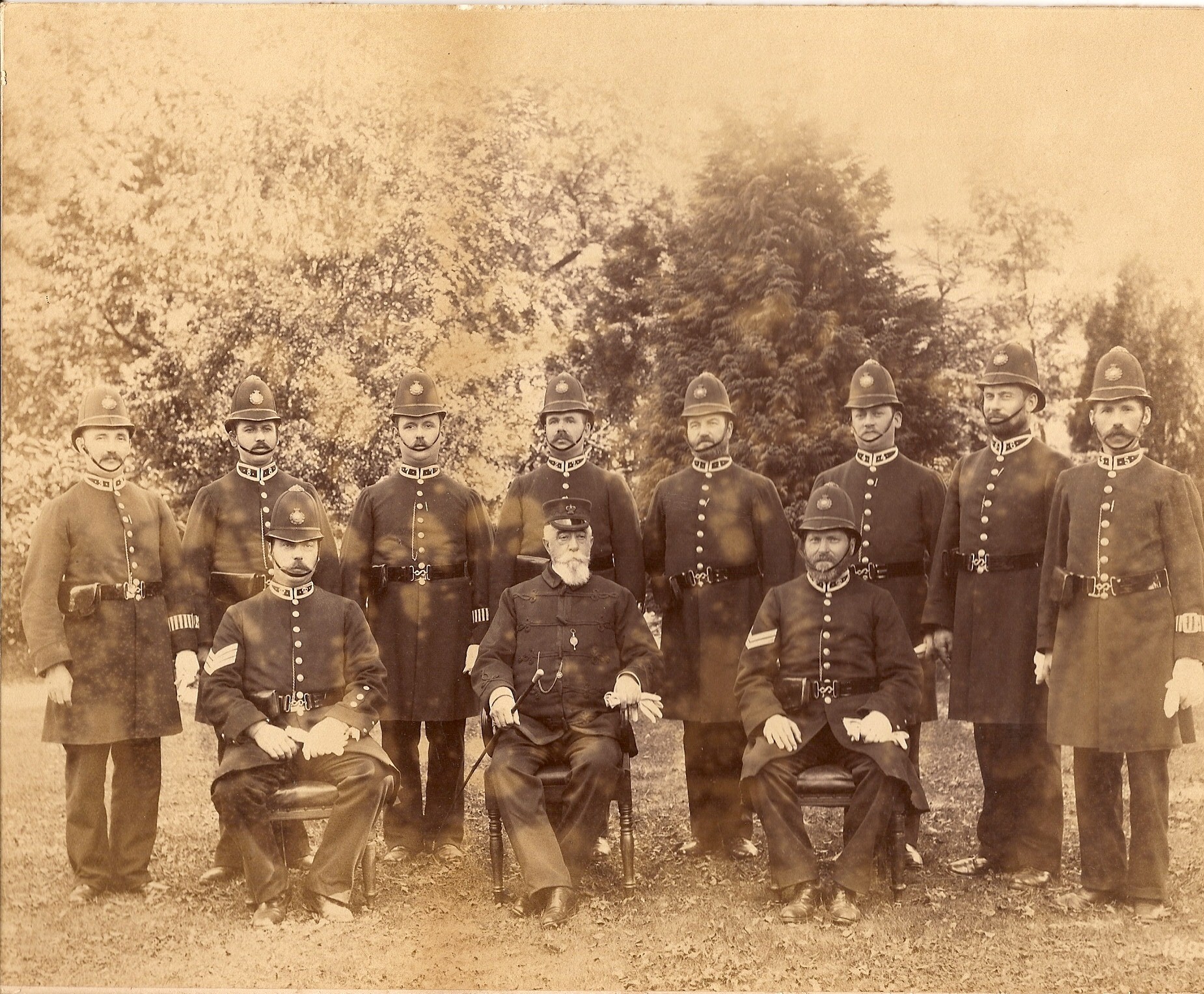Tiverton Police Force in 1898. A group of men in old fashioned police uniform, some seated some standing.