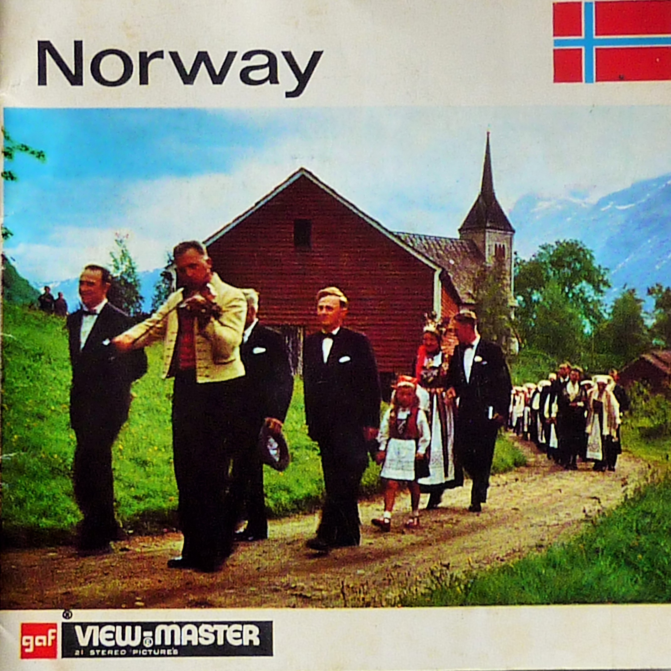 The cover of an accompanying booklet to a Viewmaster slide of images from Norway. The photo featured on the cover shows a procession of people presumably in traditional Norwegian dress walking away from what looks to be a church.