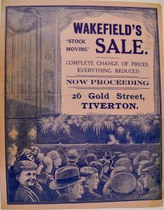 A newspaper advert for Wakefield's featuring an illustration of an audience at a theatre. Projected on to the illustrated curtains is the wording 'Wakefield's Stock Moving sale'.
