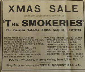 Newspaper advert for a Xmas Sale at 'The Smokeries' - The Tiverton Tobacco House. There is a list of all sorts of products like cigar cases and cigarette holders and an offer to 'shop early and secure the Special Discount.