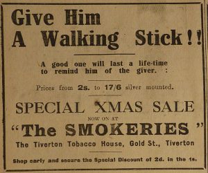 Newspaper Advert for 'The Smokeries' Tiverton Tobacco House. The slogan reads 'Give him a Walking Stick!! A good one will last a life-time to remind him of the giver'. 