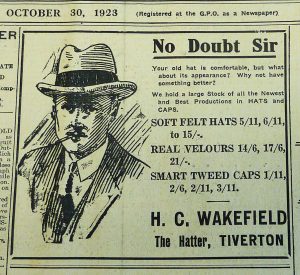 A newspaper advert dated October 30, 1923, for H. C. Wakefield, The Hatter, Tiverton. It reads ' No doubt sir, your old hat is comfortable, but what about its appearance? Why not have something better? We hold a large stock of all the newest and best productions in hats and caps.' 