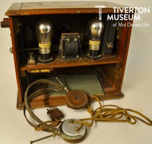 A 'Marconi' radio, a brown wooden box with wires and bulbs.