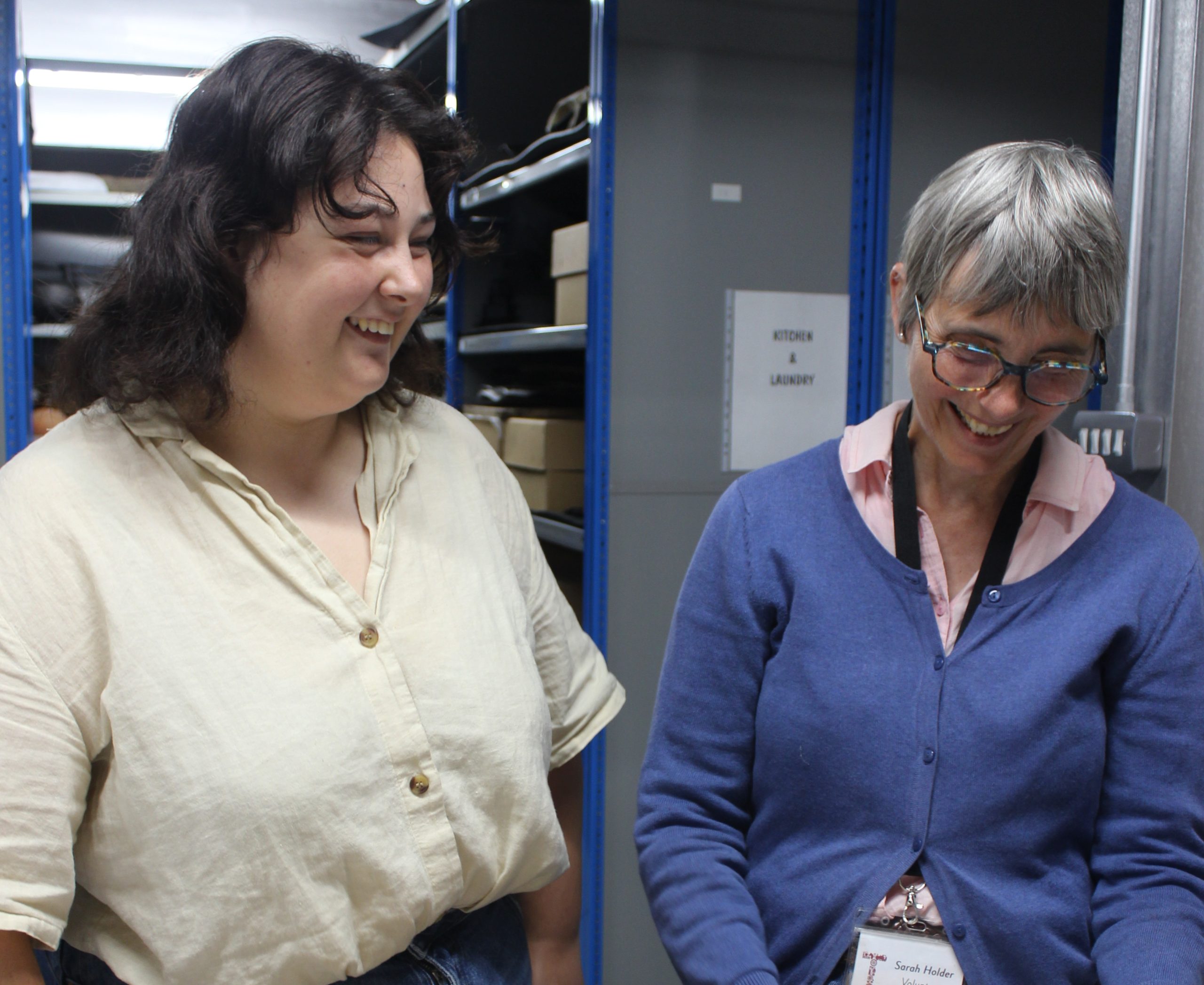 Three women standing at the counter of the museum